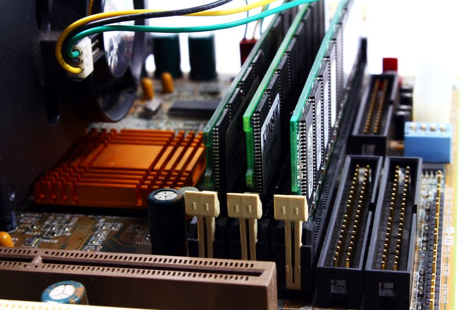 Detailed view of a computer motherboard featuring RAM modules, chipset, and intricate wiring.