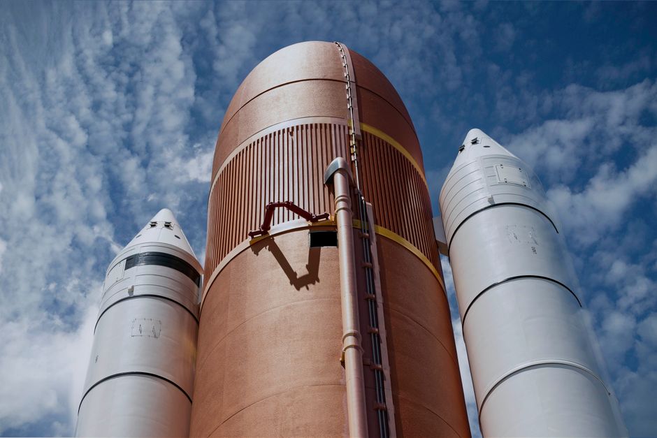Rocket boosters against a bright blue sky