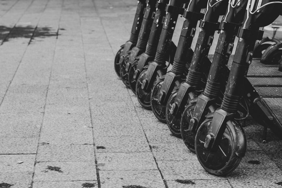 Electric scooters lined up on pavement