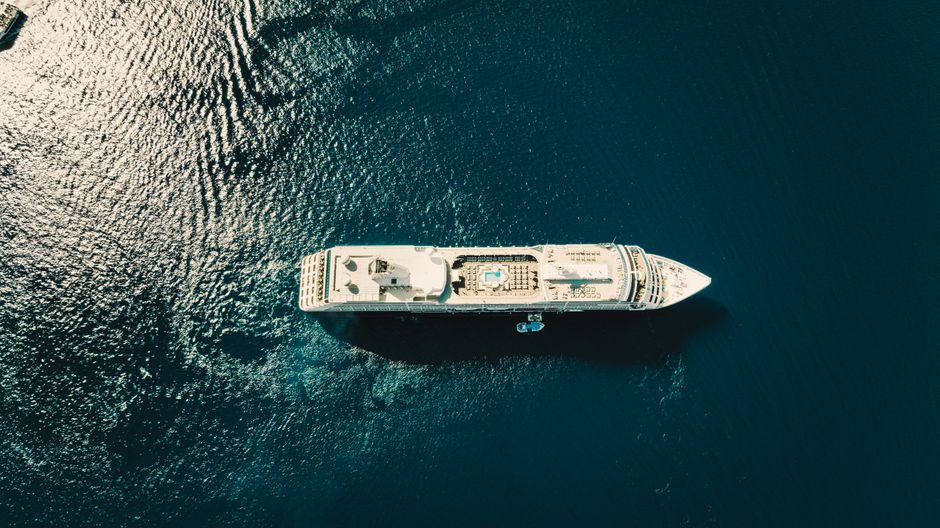 Aerial view of a large vessel sailing through deep blue ocean