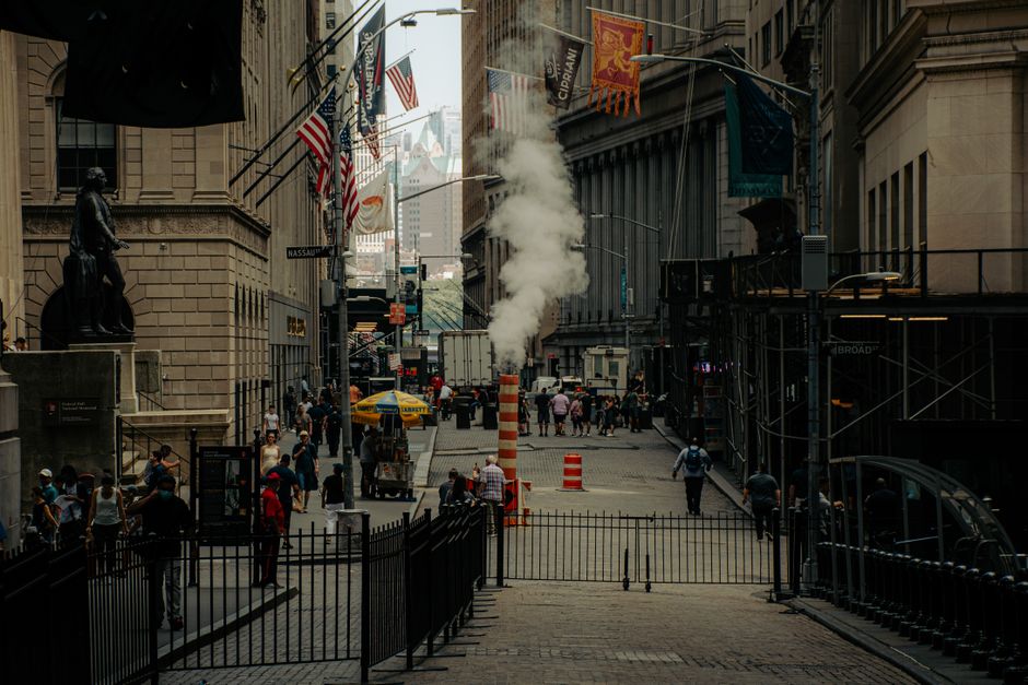 Busy New York financial district street scene with people walking