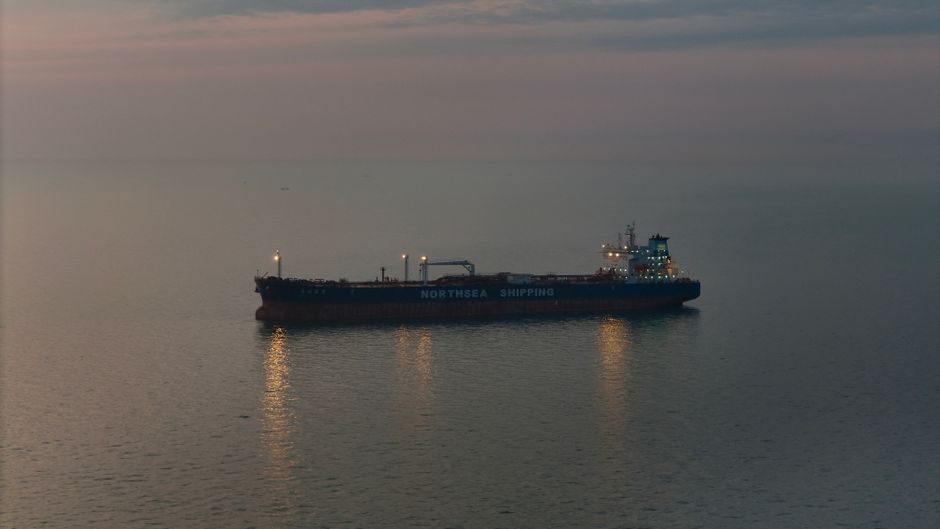 Oil tanker transiting open water, representing continued energy-cargo movement through a contested maritime chokepoint.