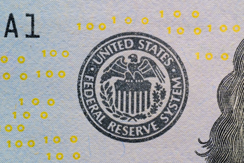 Close-up of the US Federal Reserve System seal on currency with digital numbers overlaid.