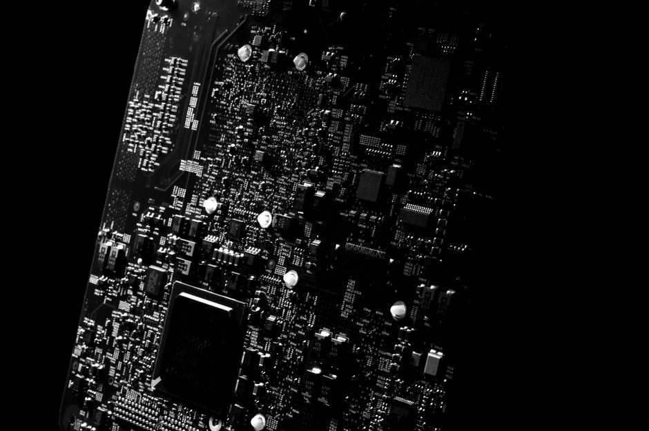 Detailed circuit-board traces representing the technology infrastructure behind the AI investment cycle.