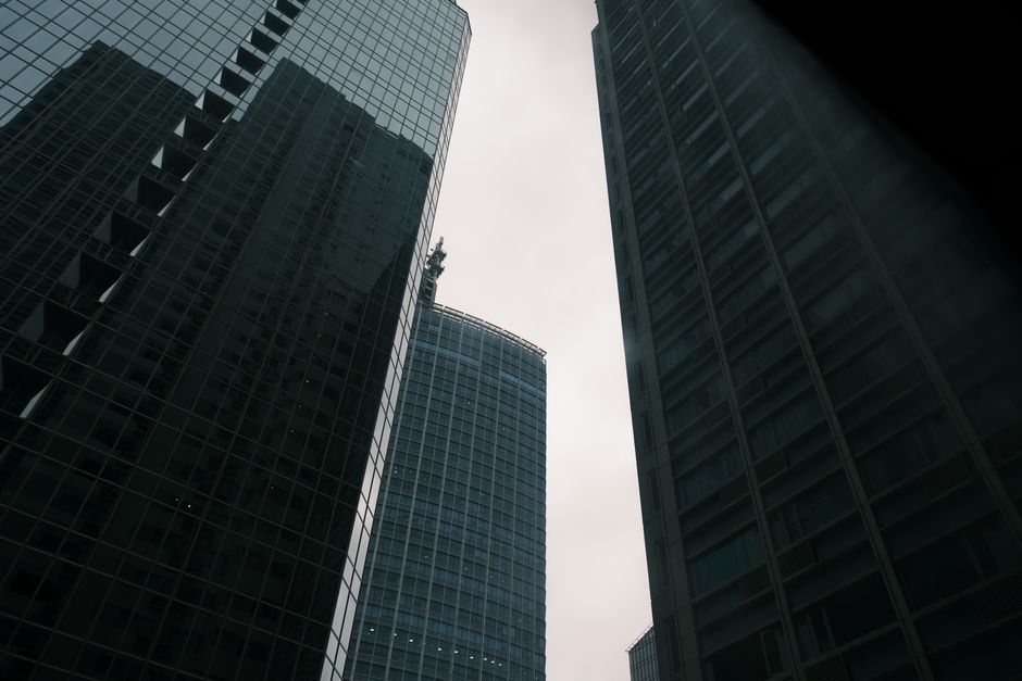 Modern skyscrapers reaching into an overcast sky, emphasizing urban architecture