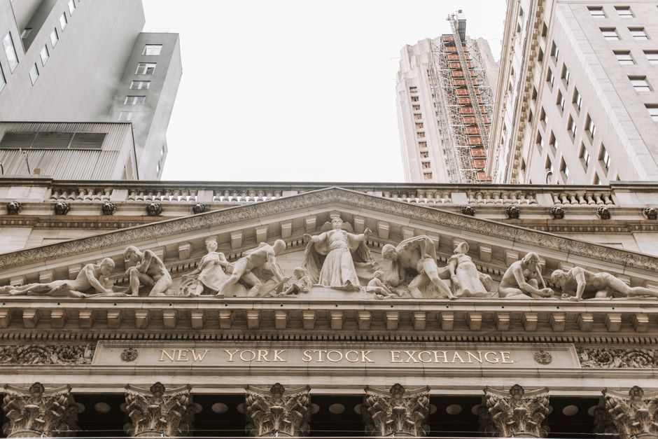 The facade of the New York Stock Exchange building with ornate architectural reliefs.