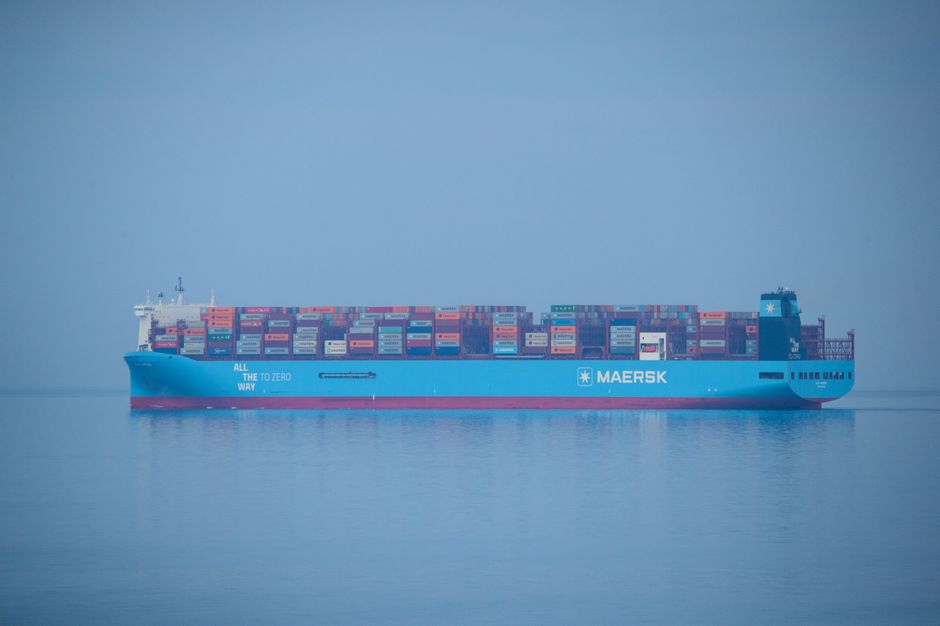 A large container ship sailing on open sea, illustrating commercial maritime shipping through a strategic waterway.