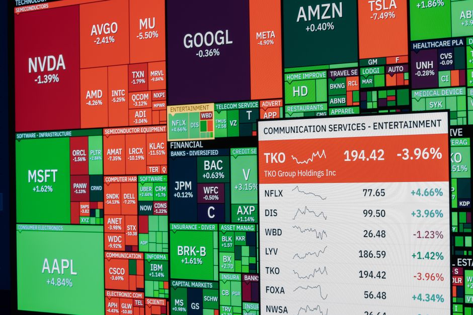 A stock-market display shows changing prices and trading data, representing the price-discovery process for new listings.