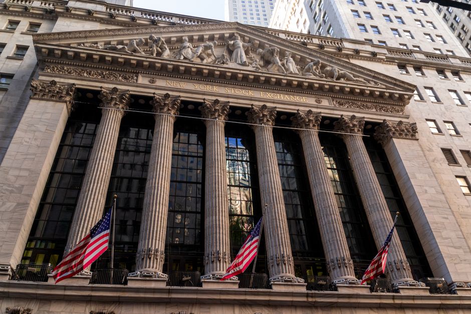Neoclassical facade of the New York Stock Exchange with American flags