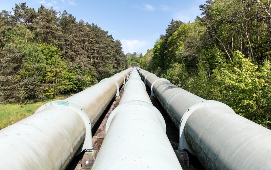 Industrial pipeline infrastructure carries energy across a landscape.