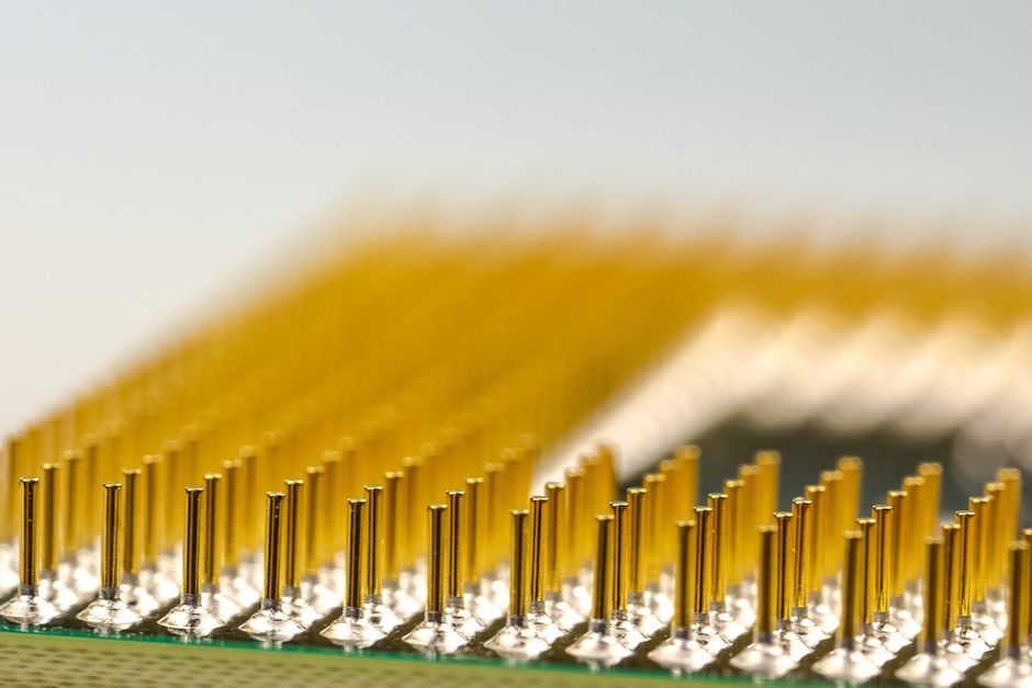 Macro shot of a CPU microchip with golden pins, highlighting semiconductor detail.
