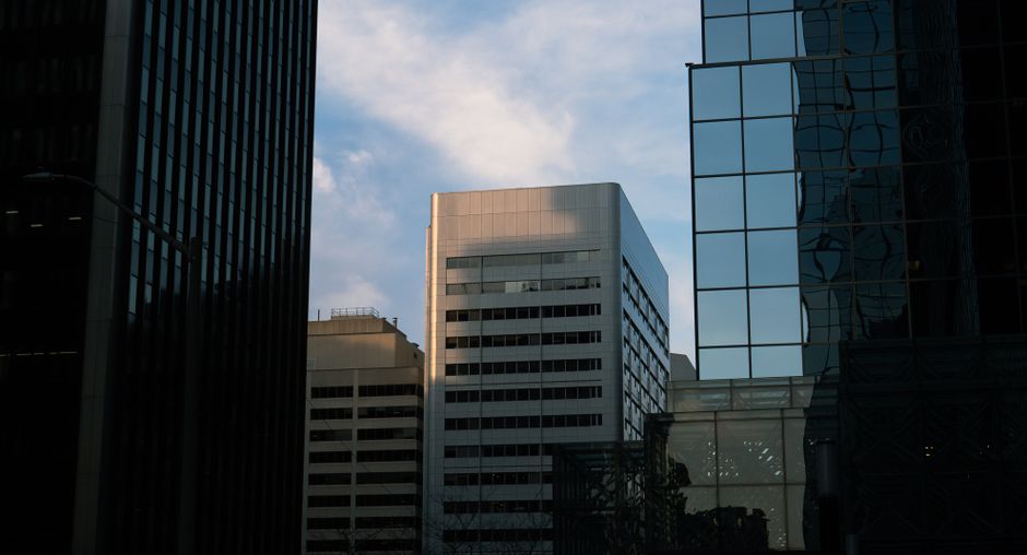 Modern city skyline with glass skyscrapers reflecting sky at golden hour