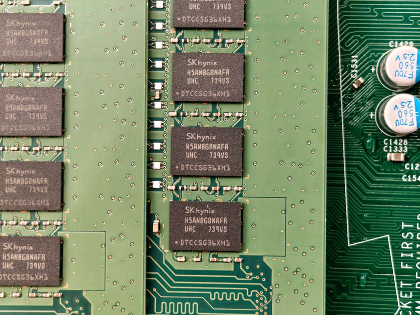 Close-up of a green circuit board with memory chips and electronic components