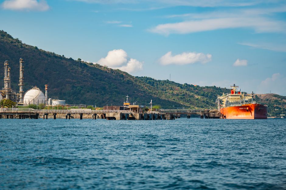 A large oil tanker docked at an industrial port