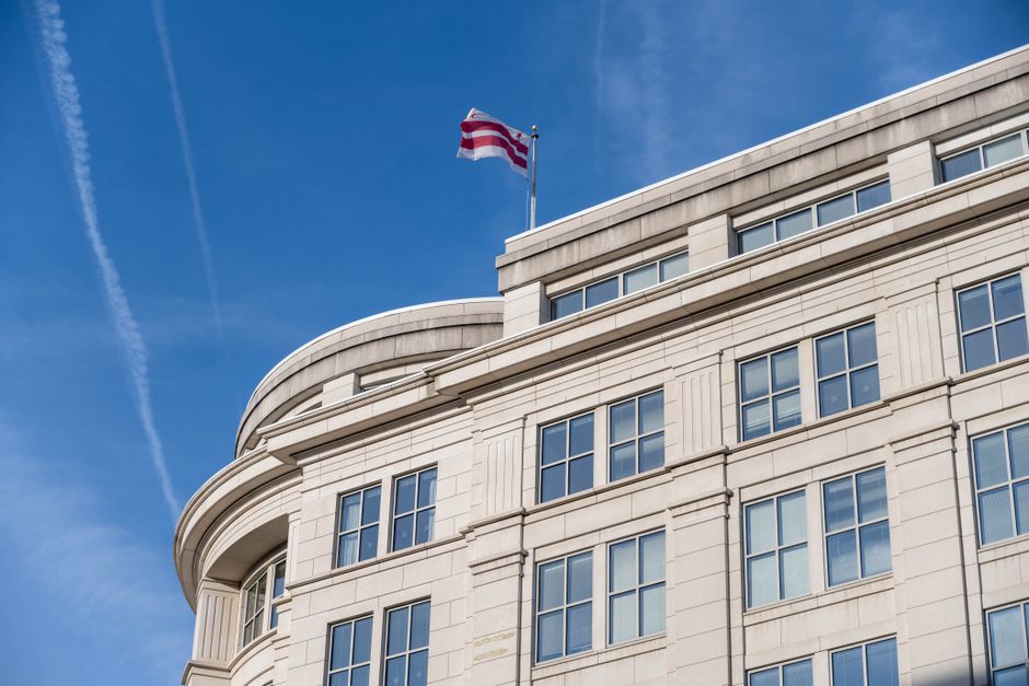 Building in Washington DC with District of Columbia flag waving