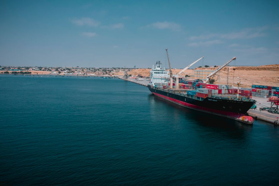 Cargo ship and port infrastructure represent the freight route through which Middle East conflict can reach company margins.