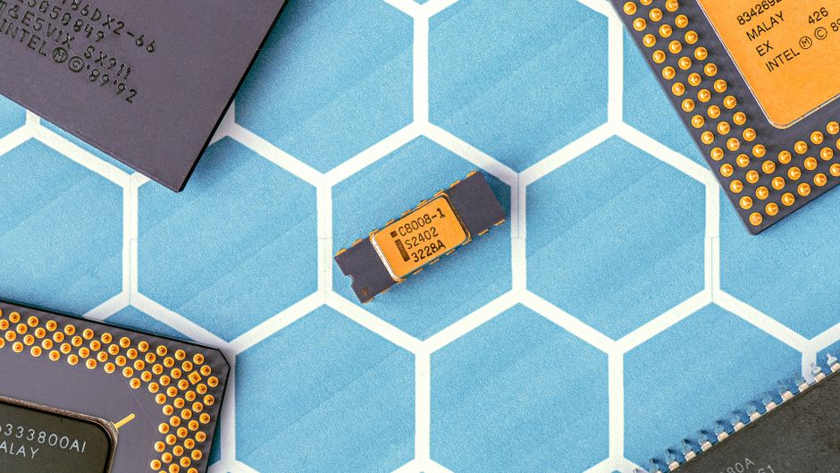 Close-up of microprocessor chips on a blue hexagonal patterned surface highlighting electronic circuitry