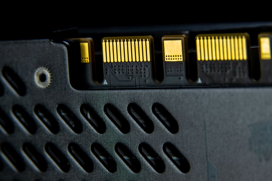 Macro shot of a computer part showcasing intricate electronic connections and gold contacts