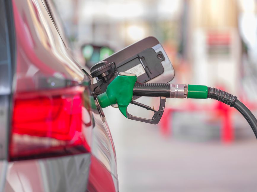 Close-up of a fuel pump nozzle at a gas station