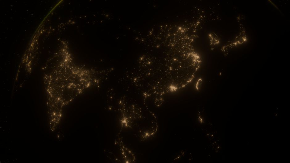View of Asia and the Middle East from space at night, showing glowing city lights across the region