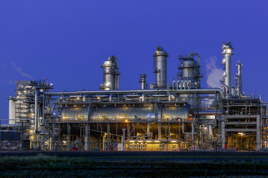Industrial petrochemical facility illuminated at dusk