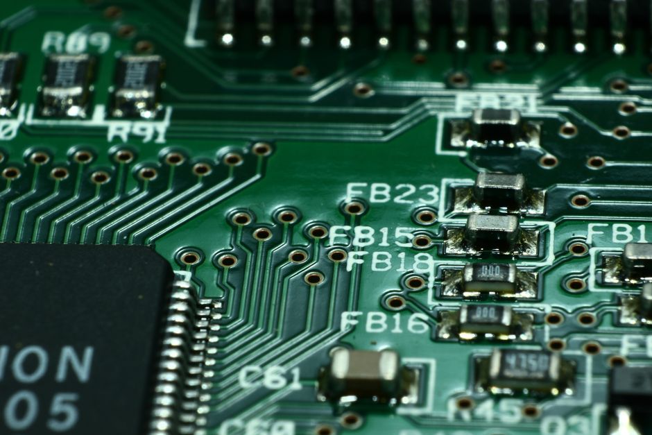 Macro view of a green circuit board with microchips and electronic components