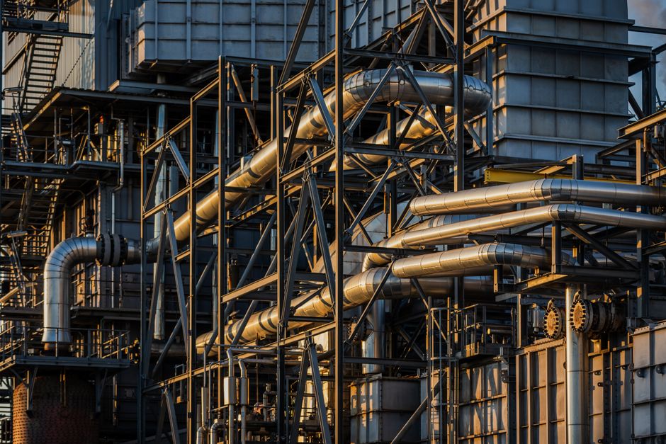 Industrial refinery complex with network of pipes and storage tanks.