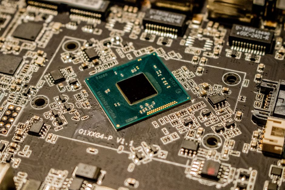 Close-up of a microchip and circuit board representing semiconductor leadership in the stock market