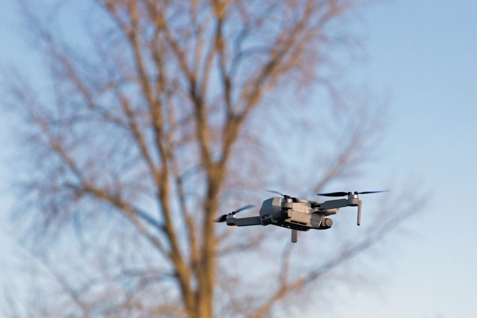 A drone hovering against a clear sky, representing the type of aerial threat now targeting energy infrastructure near critical shipping lanes.