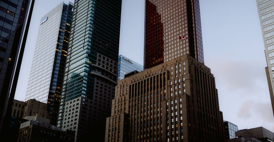Modern financial district skyscrapers against a darkening evening sky