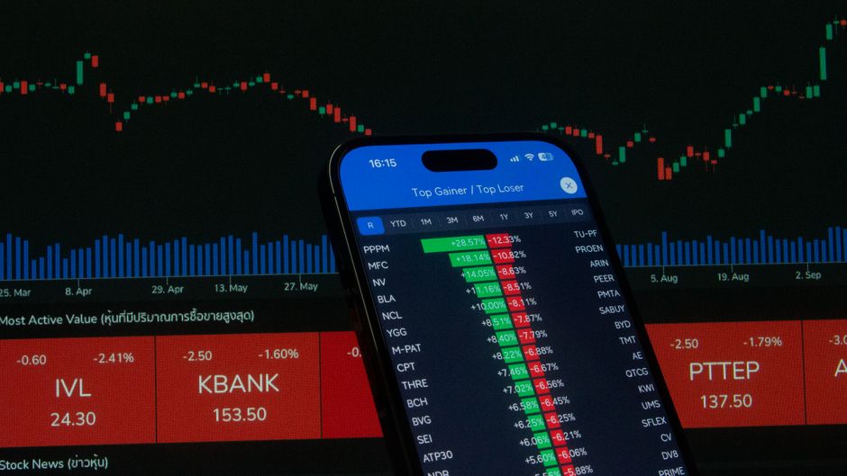 A smartphone displays market data while equity supply and liquidity shape price discovery.