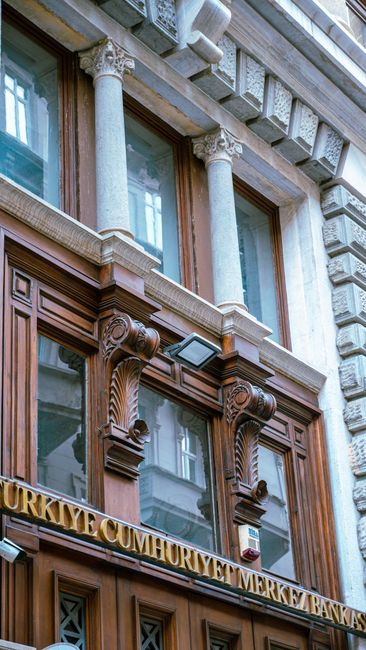 Ornate neoclassical bank building facade with carved stone columns
