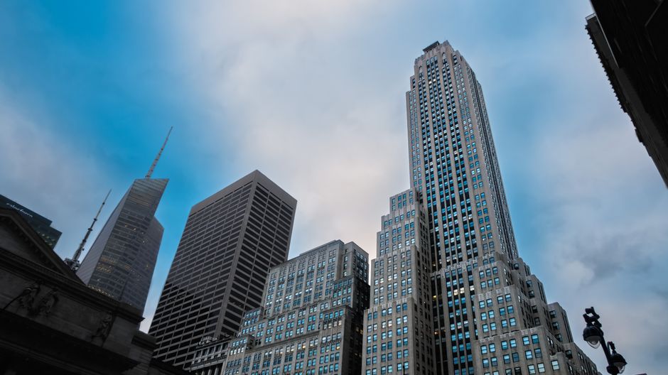 Modern financial-district buildings representing the public-market infrastructure