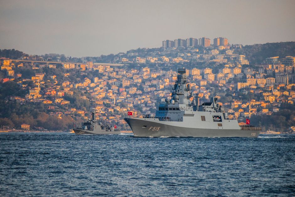 Naval warships navigating near a coastline