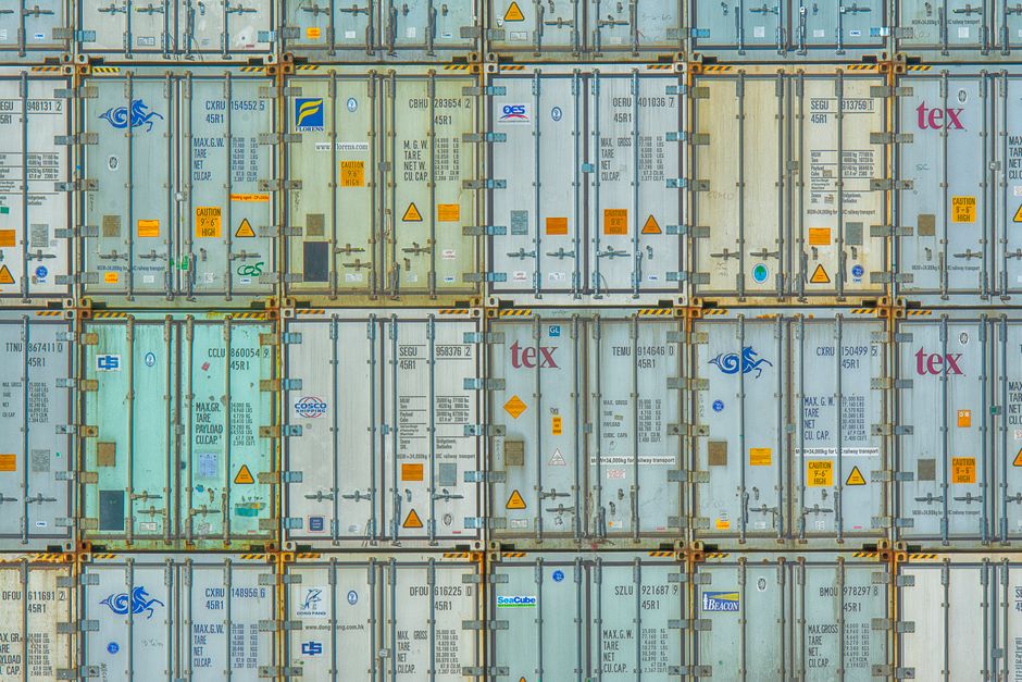 Stacked shipping containers at an industrial logistics facility