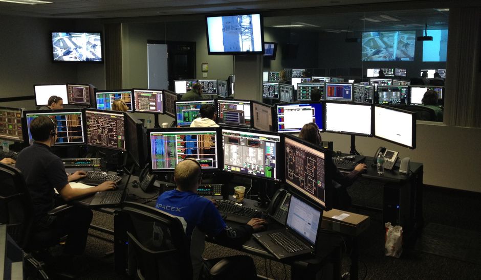 Software engineers monitor enterprise technology operations in a control room.