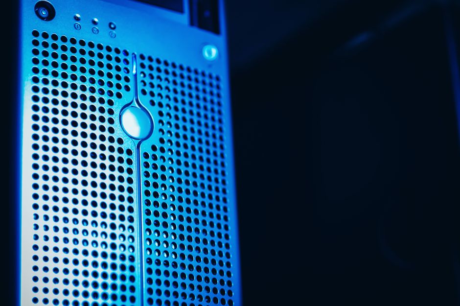 Modern server rack with blue lighting in a secure data center environment, representing the AI infrastructure driving the semiconductor rebound.