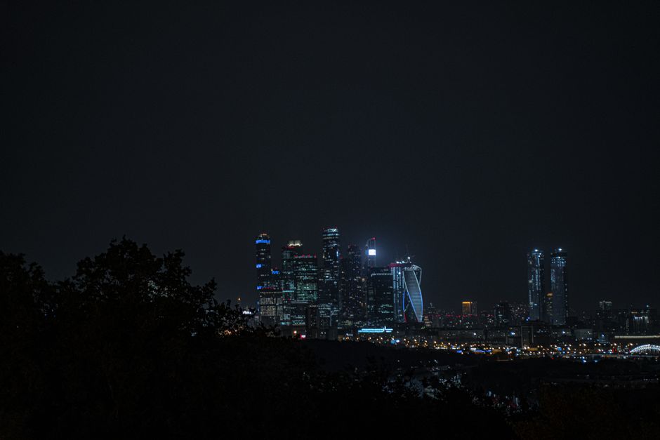Nighttime city skyline with illuminated skyscrapers