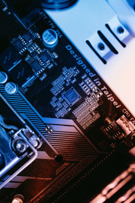 Macro shot of a computer motherboard focused on chips and circuits.
