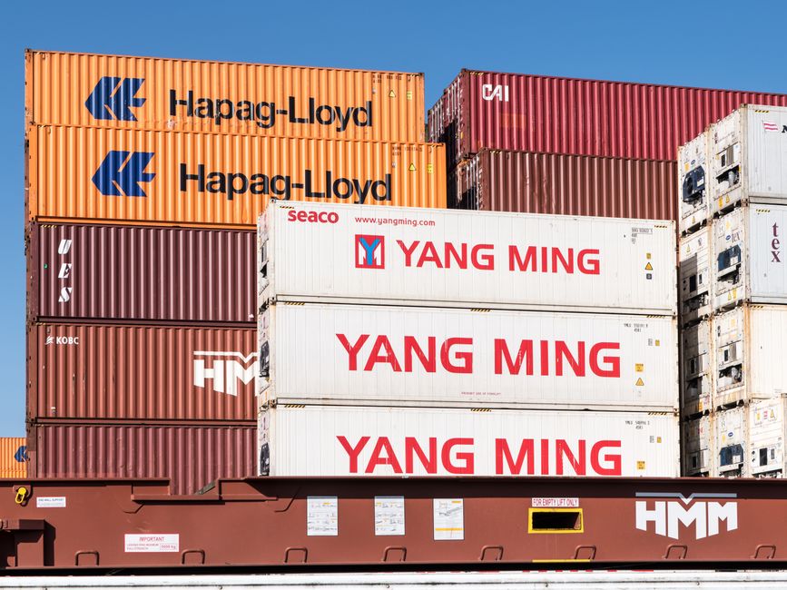 Shipping containers stacked at a busy port terminal