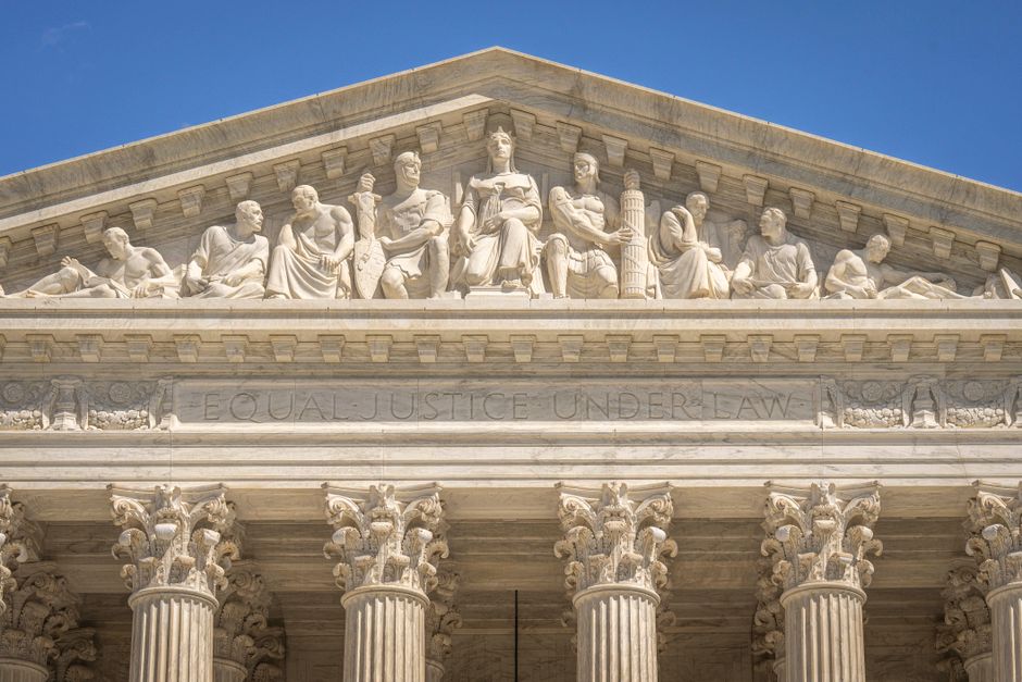 Supreme Court Building frontal frieze depicting historical figures.
