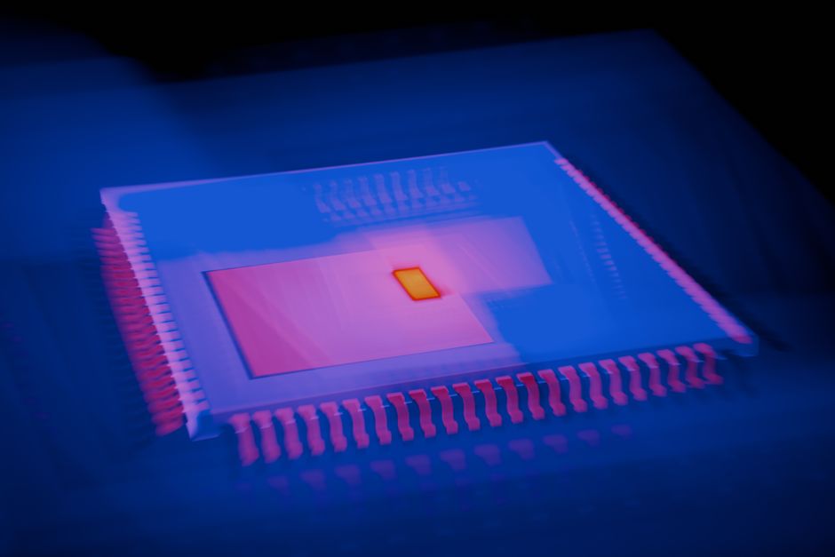 Abstract close-up of a microchip processor with heatmap-style color gradients.