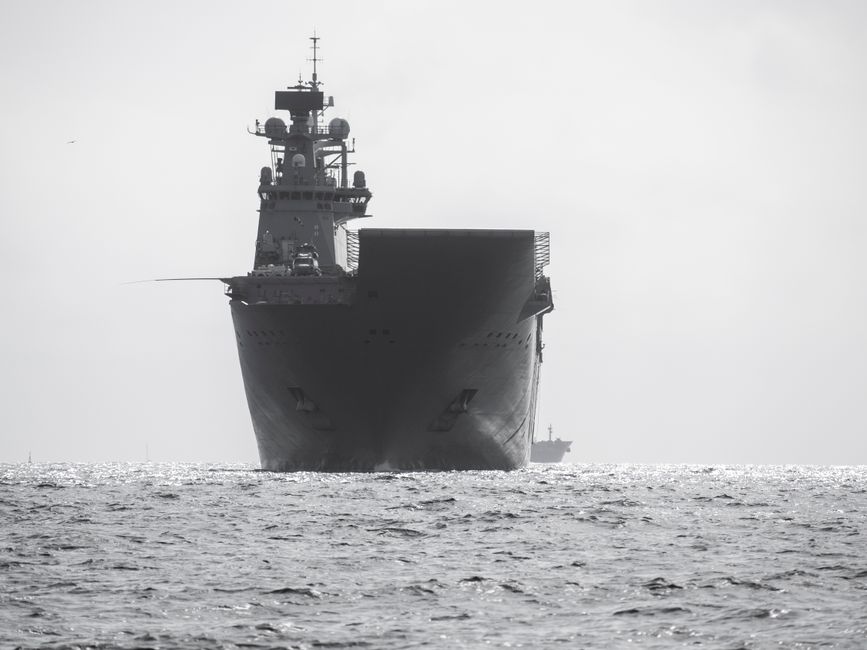 A powerful aircraft carrier navigates through the open sea