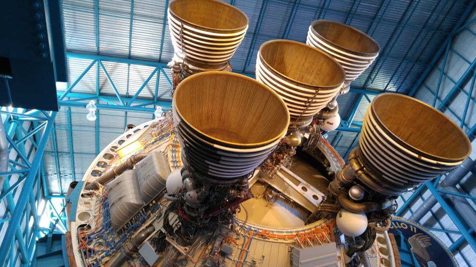 Close-up of large rocket engine nozzles showing intricate metallic engineering.