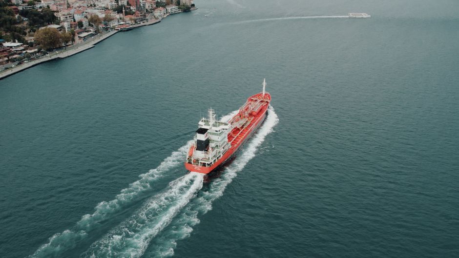 Aerial view of a cargo ship navigating a strategic maritime channel