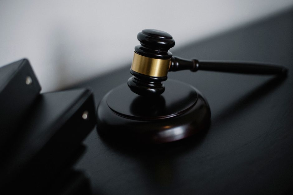 Wooden gavel and legal documents on a desk