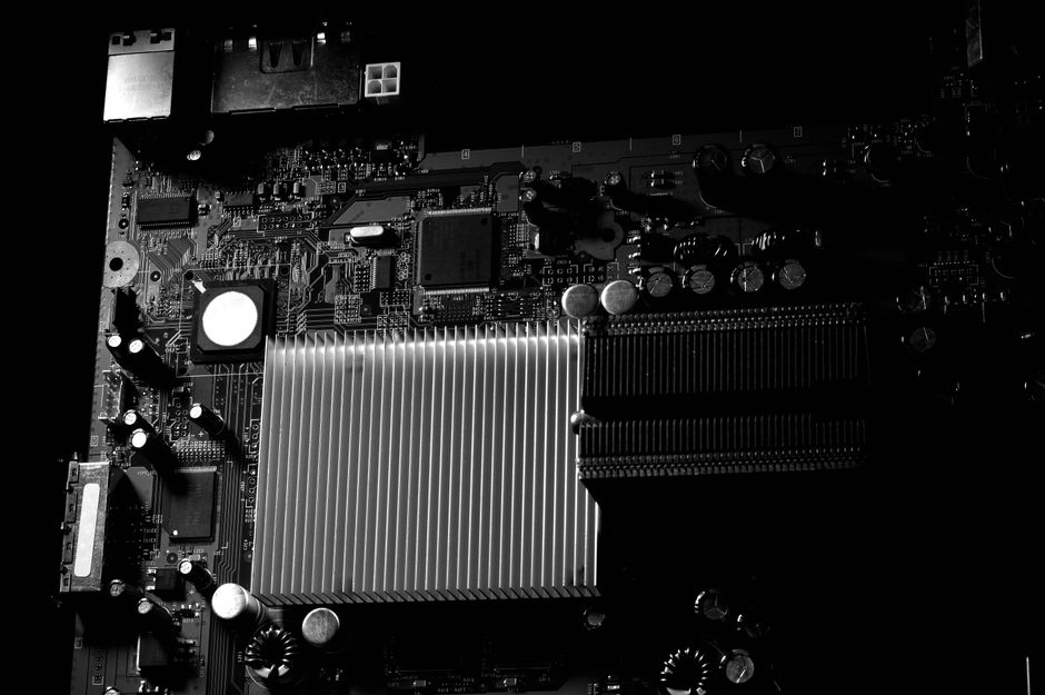 Computer motherboard with a prominent heatsink representing semiconductor infrastructure
