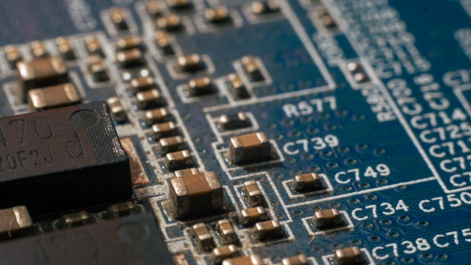 Macro view of an electronic circuit board with chips and conductive traces