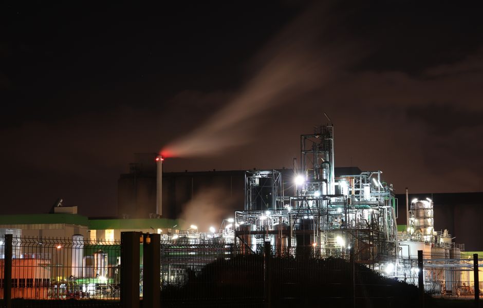 Illuminated refinery infrastructure representing the refined-fuel supply channel exposed to geopolitical disruption.